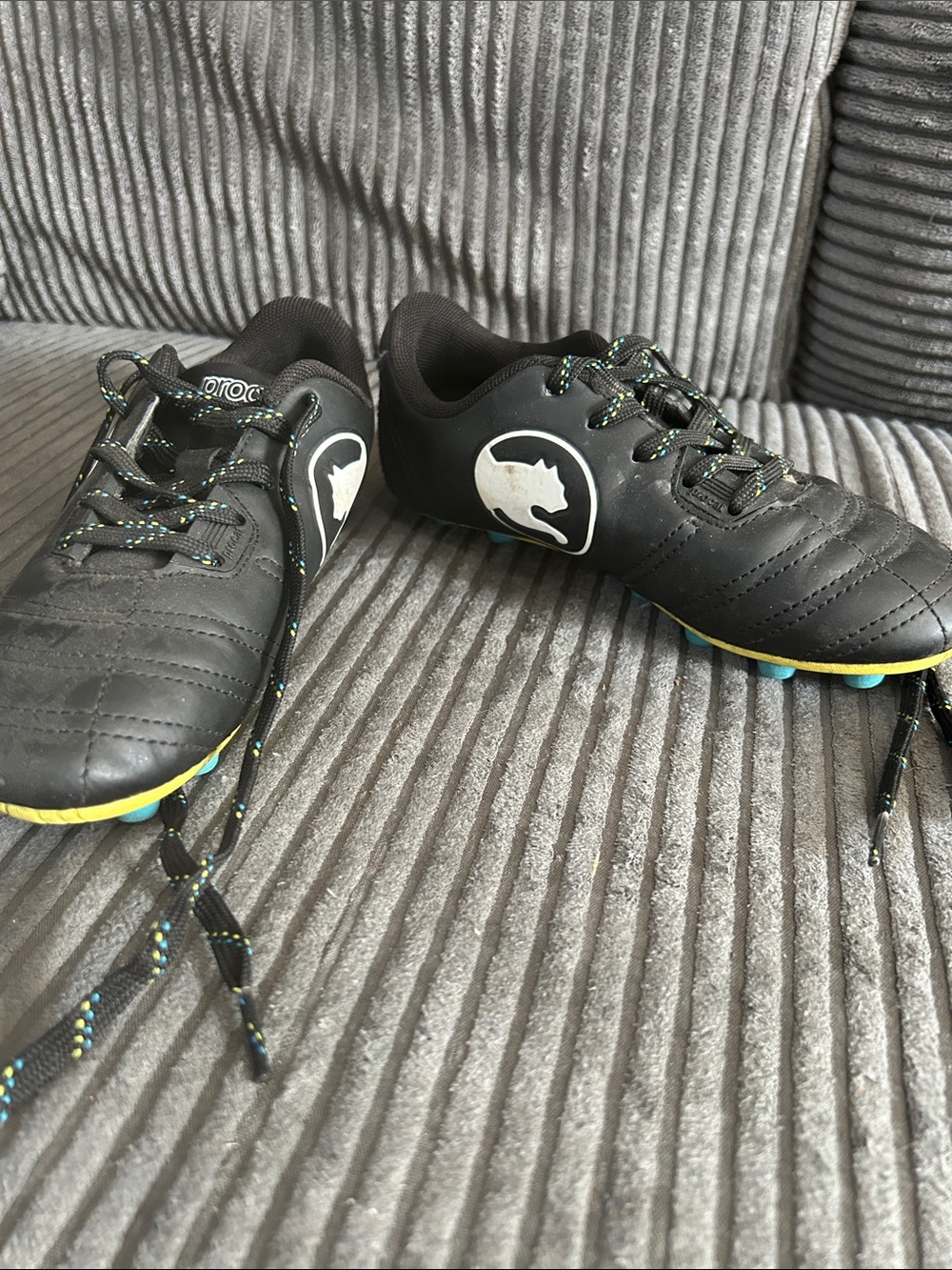 Kids Black Soccer Cleats with Yellow Accents